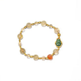 8.5mm Golden Rutilated Quartz bracelet featuring Red Agate and a carved Jade Hulu charm on white background.