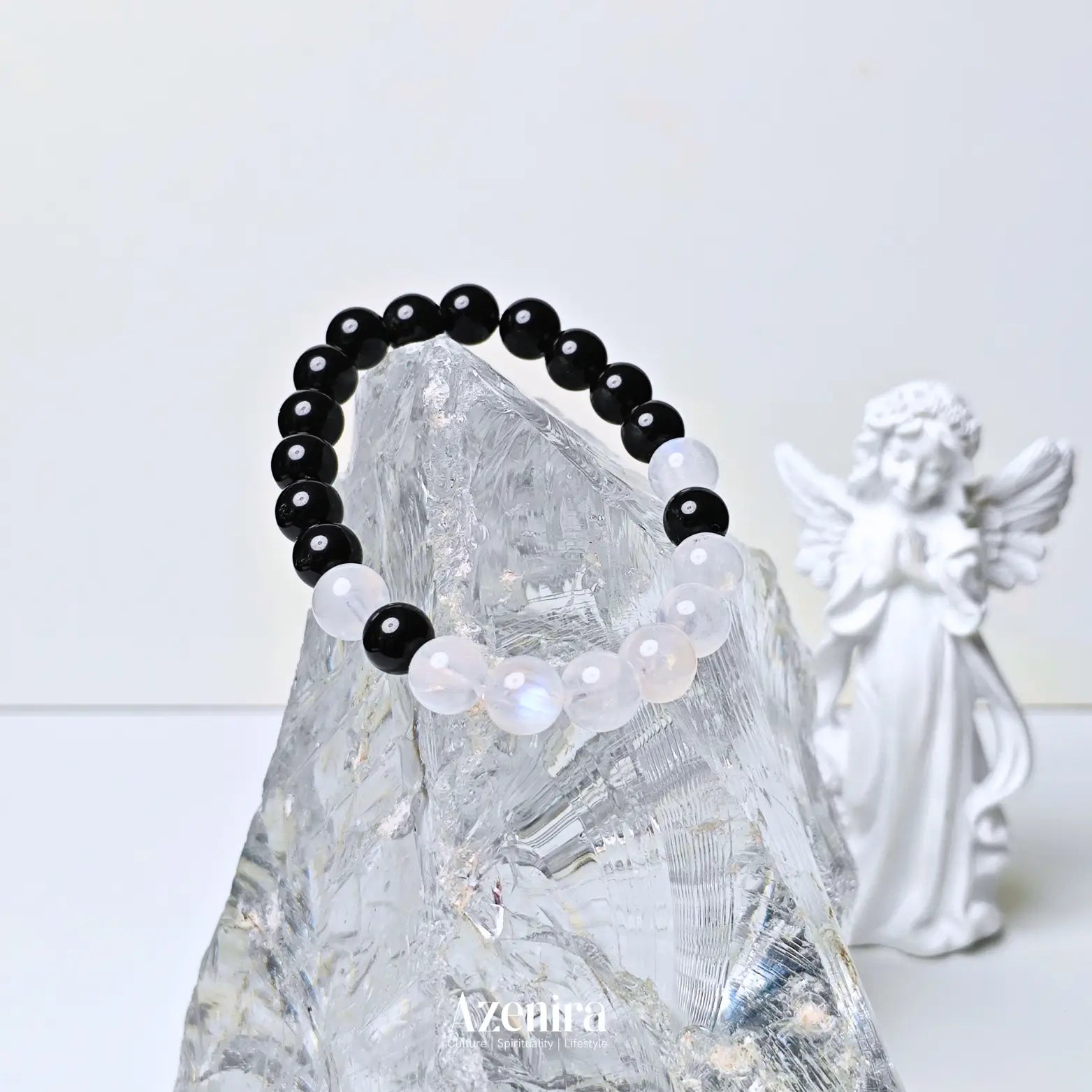 Handcrafted moonstone and obsidian bracelet featuring a dual crystal design inspired by protection, intuition, balance, and personal intention