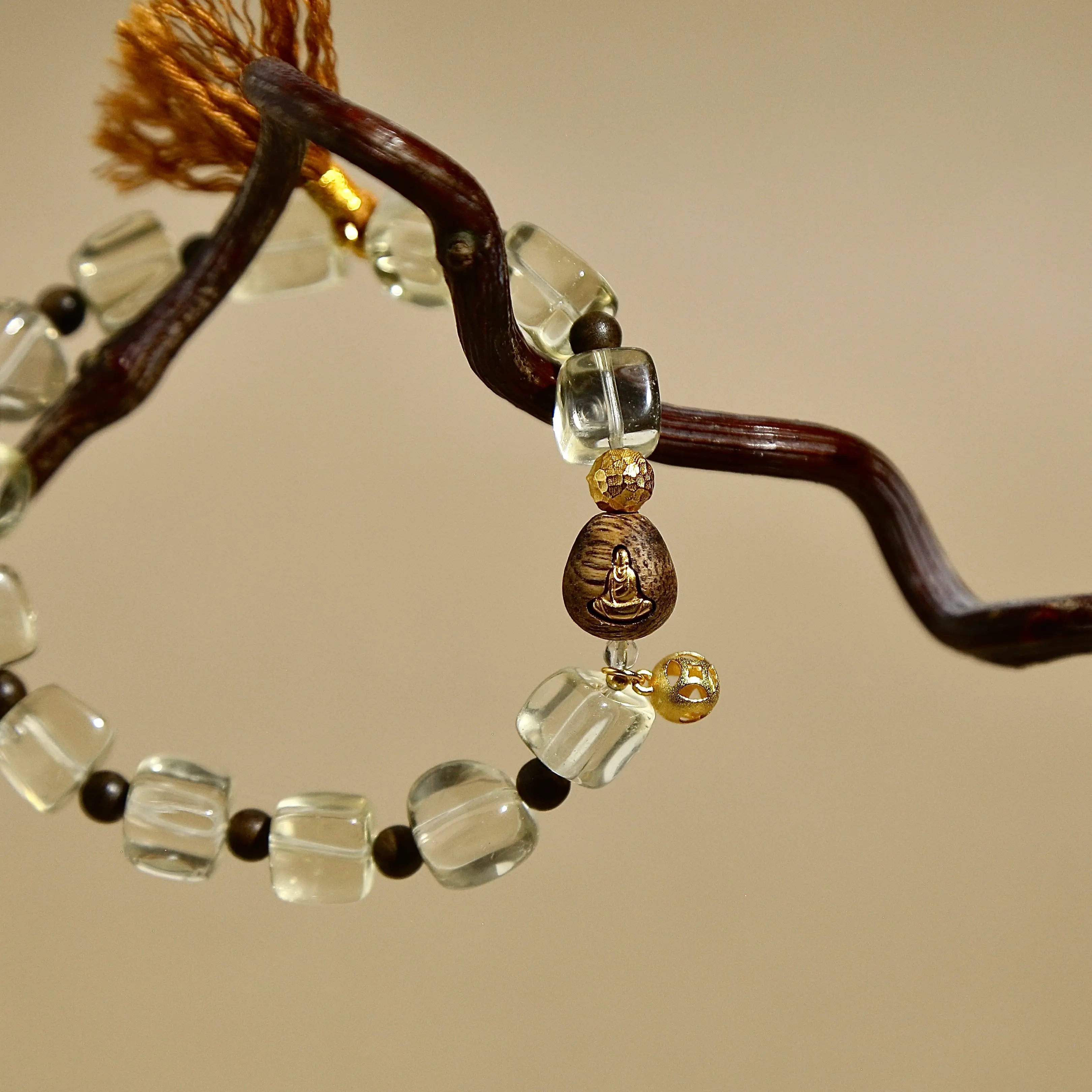 Faceted natural Citrine crystal bracelet featuring a brown tassel and vintage metal charm.