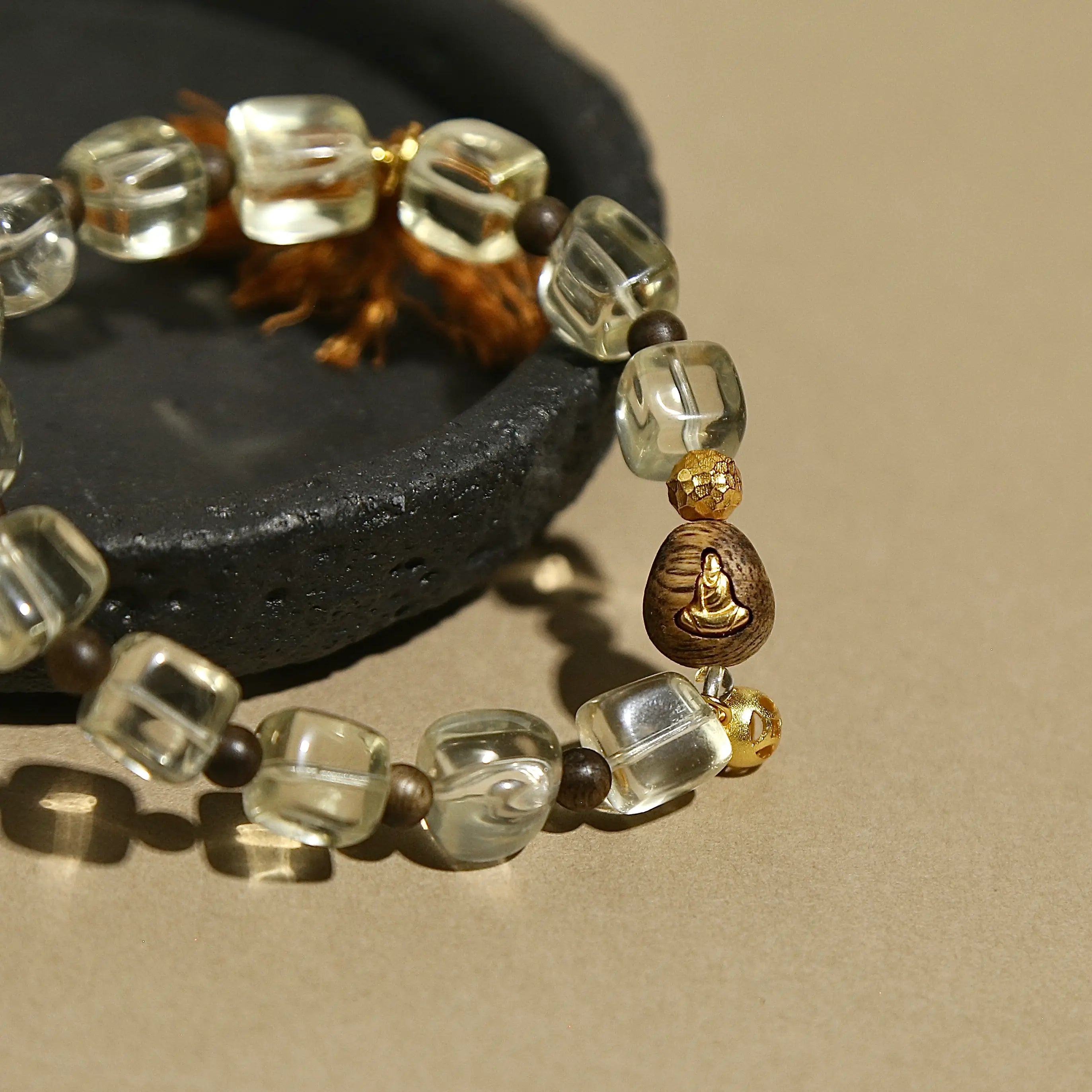 Faceted natural Citrine crystal bracelet featuring a brown tassel and vintage metal charm.