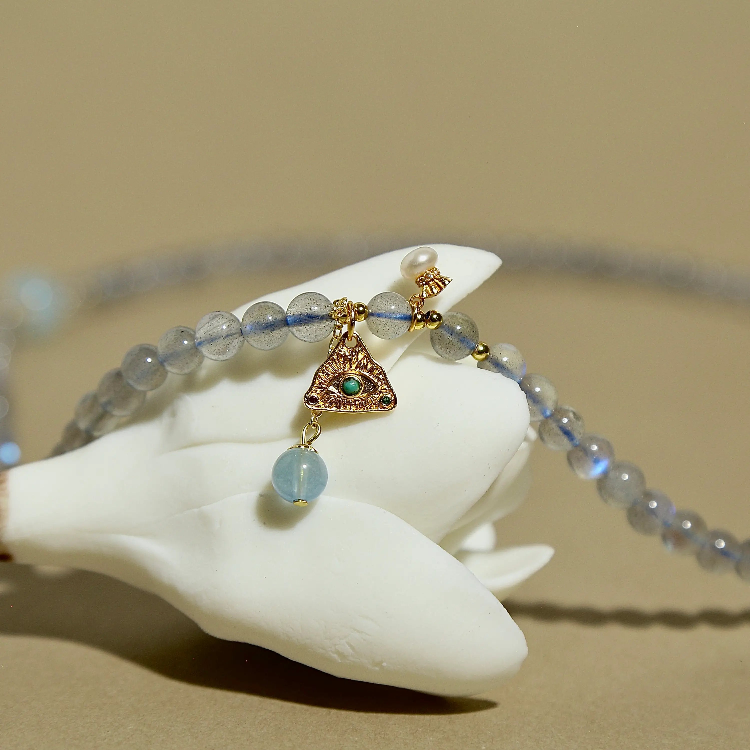 Natural labradorite beaded wrap bracelet featuring a gold triangle charm and small pearl accent.
