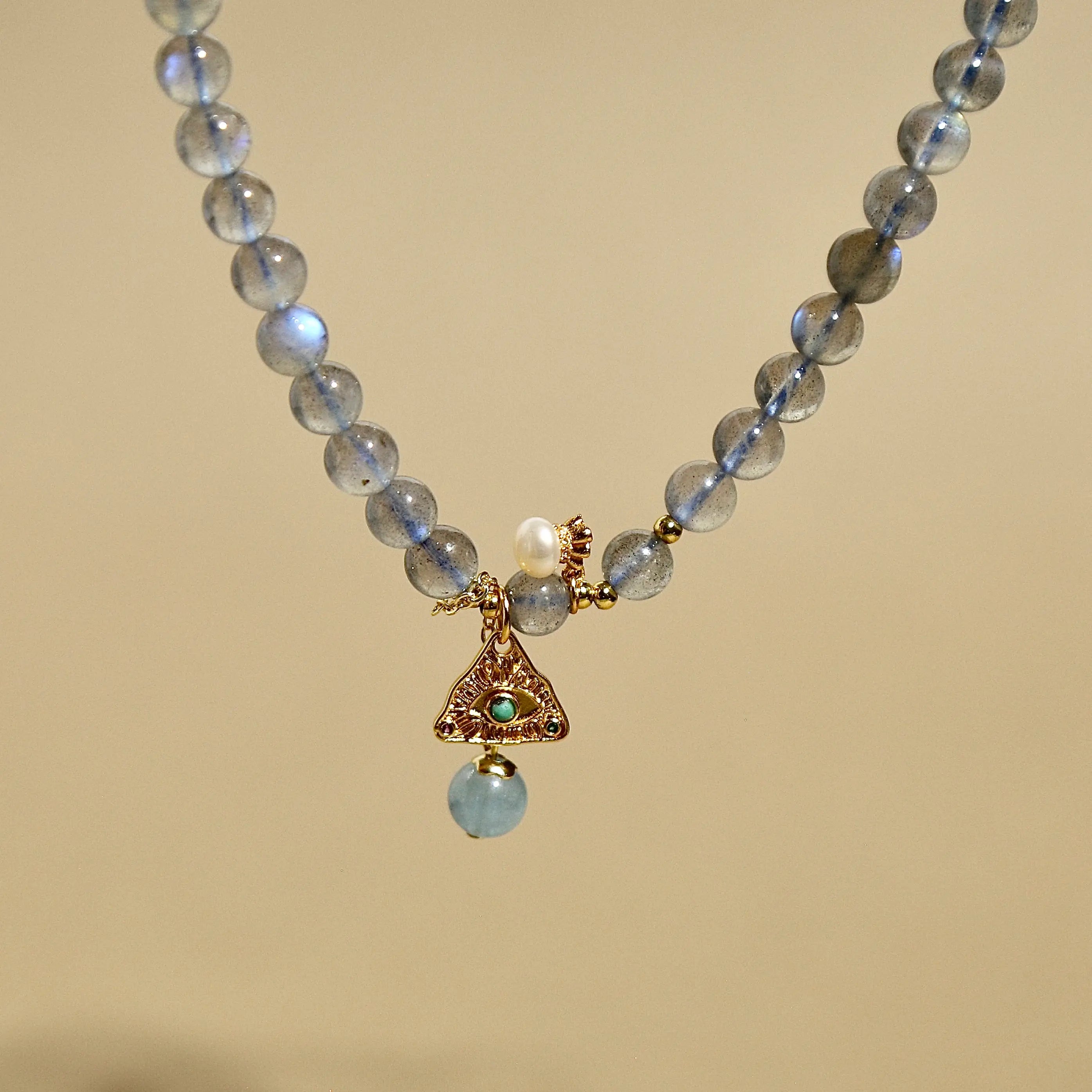 Natural labradorite beaded wrap bracelet featuring a gold triangle charm and small pearl accent.
