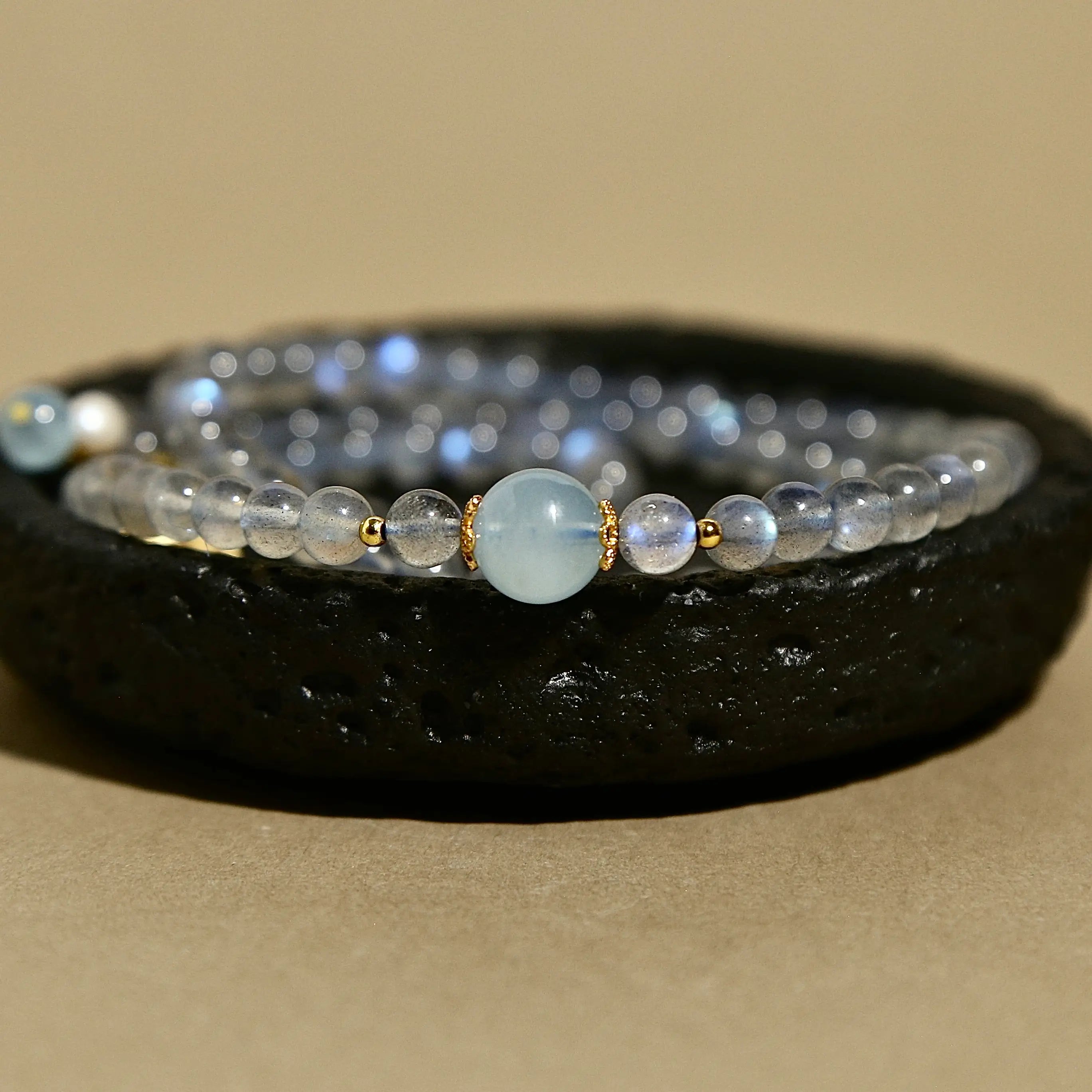 Natural labradorite beaded wrap bracelet featuring a gold triangle charm and small pearl accent.