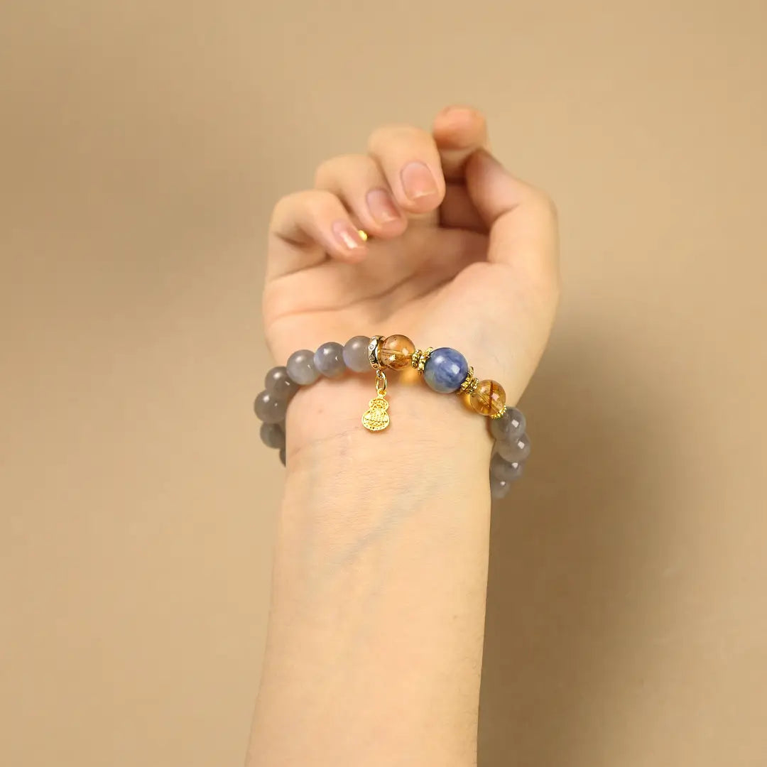 Woman wearing a beaded gemstone bracelet on wrist, showing the 10mm bead size and fit.