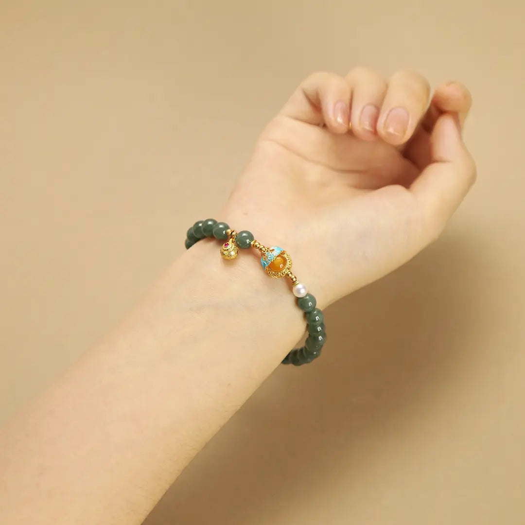Woman wearing an elegant Blue Jadeite gemstone bracelet on wrist, perfect for daily wear or special occasions.