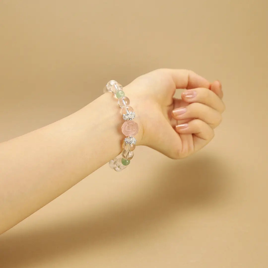 Woman wearing a Clear Quartz and Rose Harmony bracelet on wrist to show 10mm bead size and fit.