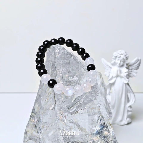Handcrafted moonstone and obsidian bracelet featuring a dual crystal design inspired by protection, intuition, balance, and personal intention