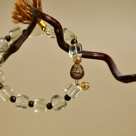Faceted natural Citrine crystal bracelet featuring a brown tassel and vintage metal charm.